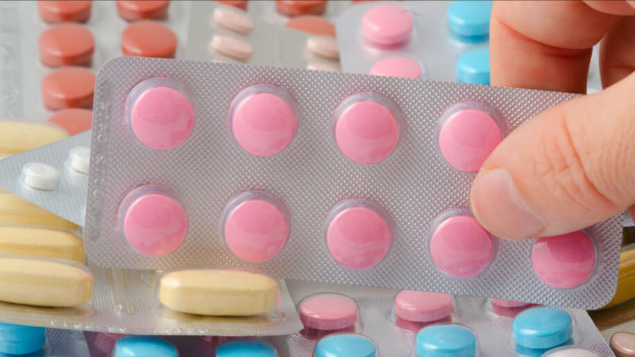 Person taking arthritis medication at home