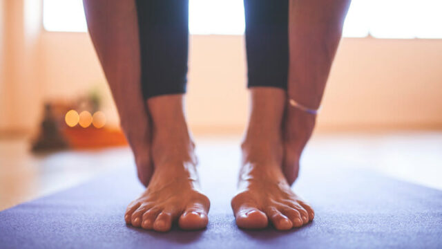 A women doing yoga or stretching after looking into foot and ankle care