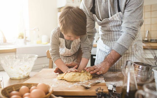 A person and child kneading dough after seeing a hand and wrist care specialist