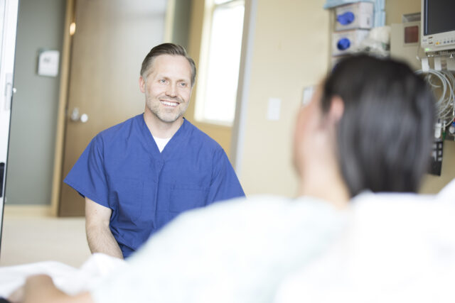 Dr. Kevin E Lindgren with a patient in a care suite