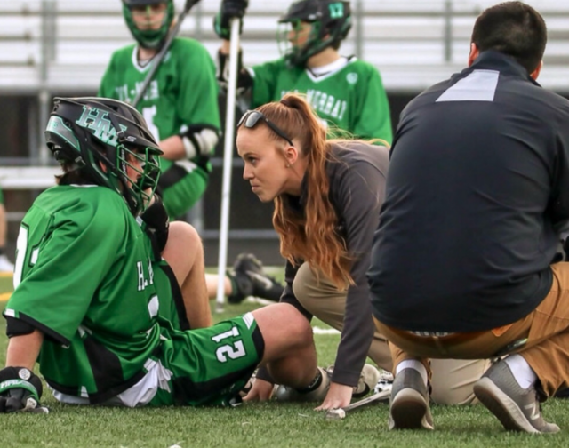 ATC helping a student in a community sporting event sponsored by Summit Orthopedics